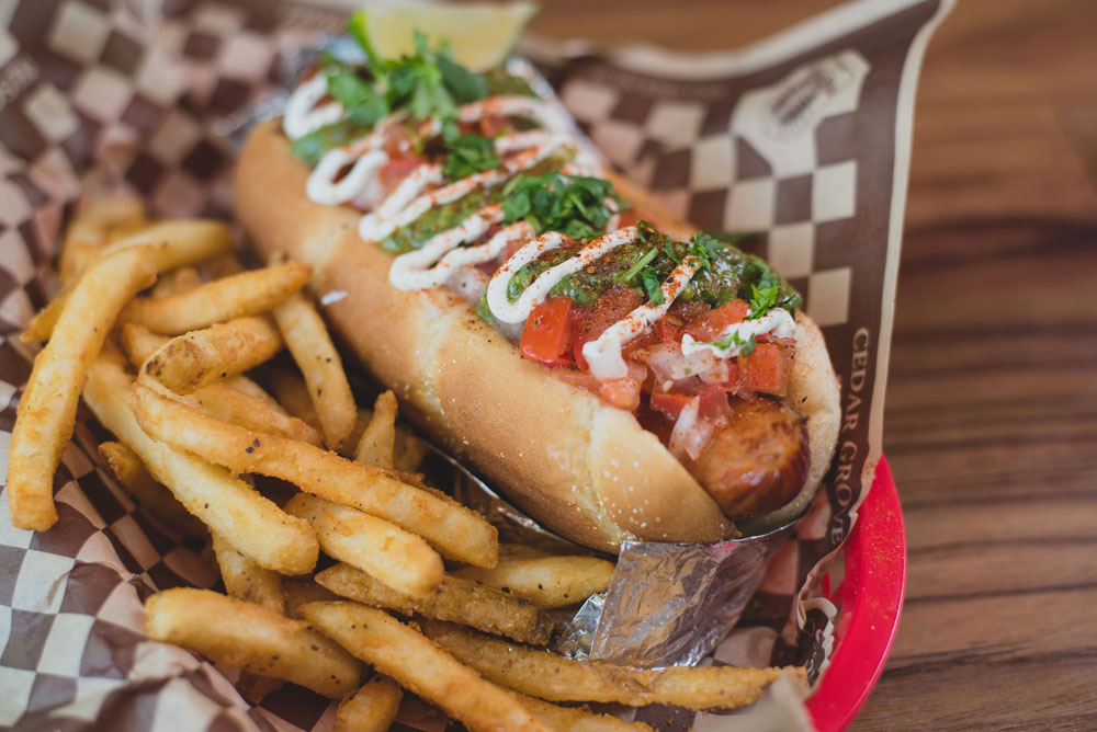 loaded hotdog with french fries on the side
